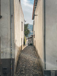 Footpath amidst buildings in city