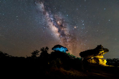 Scenic view of illuminated rock against sky at night