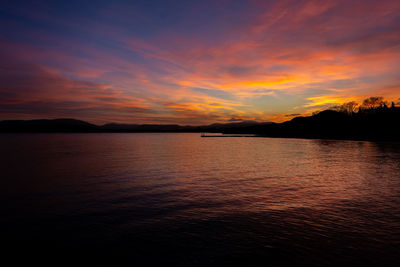 Scenic view of sea against romantic sky at sunset