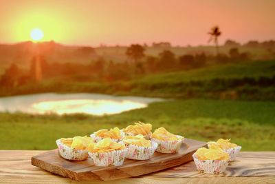 High angle view of cupcakes on table against sky during sunset
