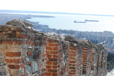 View of city by sea against sky