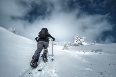 People walking on snowcapped mountain during winter