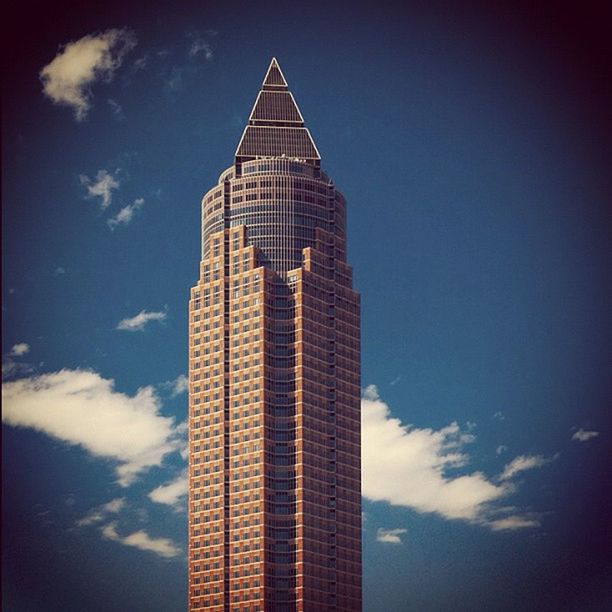 architecture, building exterior, built structure, low angle view, tower, tall - high, sky, skyscraper, tall, modern, city, auto post production filter, cloud - sky, famous place, travel destinations, outdoors, no people, transfer print, office building, cloud