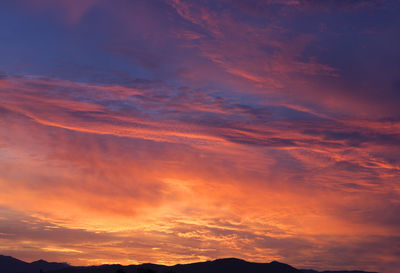 Low angle view of dramatic sky during sunset