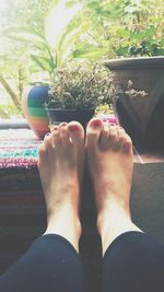 Low section of woman relaxing on tiled floor