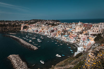 High angle view of townscape by sea against sky