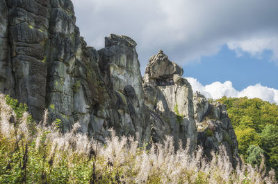 Low angle view of rock formations against sky