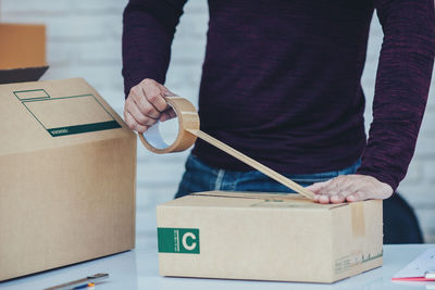 Midsection of man working on table