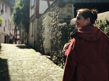 Rear view of woman walking in alley