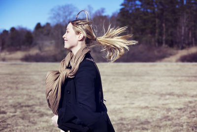 Smiling young woman walking