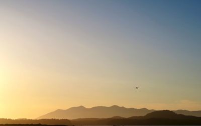 Scenic view of silhouette mountains against clear sky