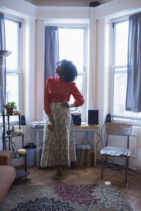 A young woman posing by windows