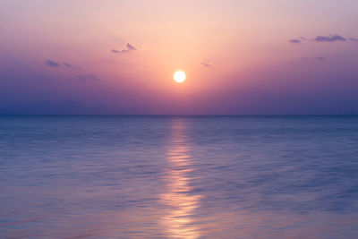 Scenic view of sea against romantic sky at sunset