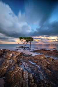 Scenic view of rocks against sky during sunset