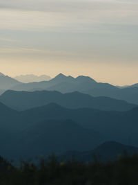 Scenic view of silhouette mountains against sky during sunset