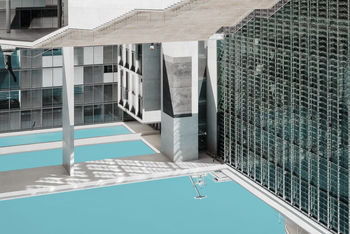 HIGH ANGLE VIEW OF SWIMMING POOL BY BUILDINGS