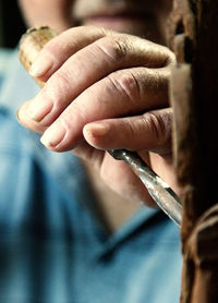 Midsection of man working on wood