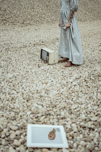 Low section of woman standing on street