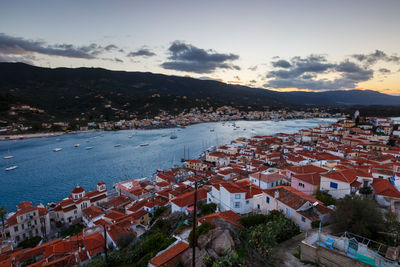 High angle view of townscape by river against sky