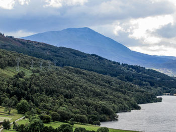 Scenic view of mountains against cloudy sky