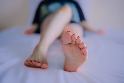 Low section of woman on bed
