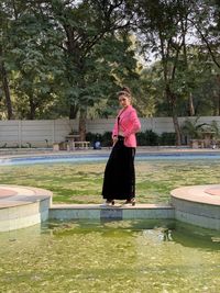 Portrait of woman standing by plants