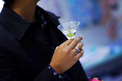 Midsection of a woman drinking glass