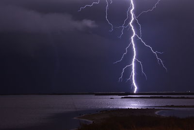 Lightning in sky over sea