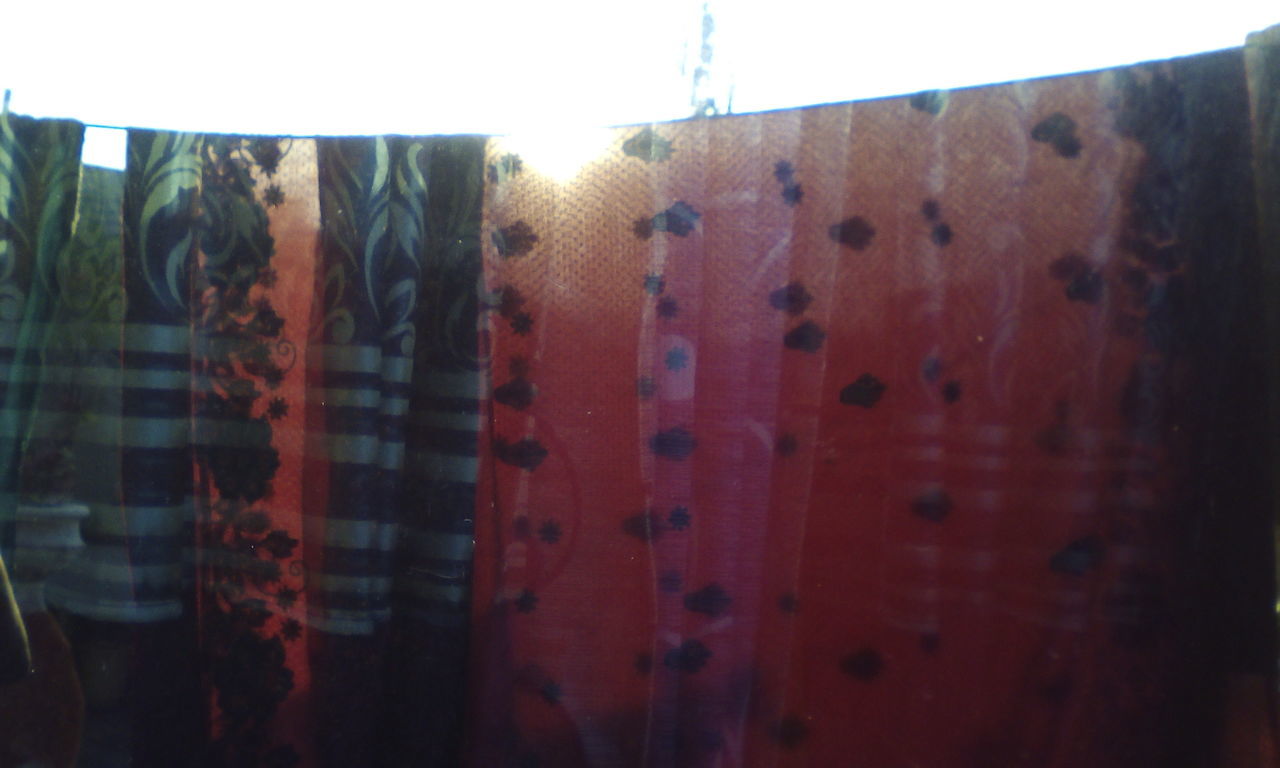 CLOSE-UP OF MULTI COLORED CLOTHES DRYING