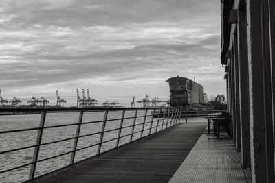 Bridge over water in city against sky