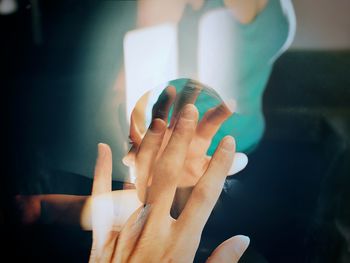 Close-up of hand holding leaf