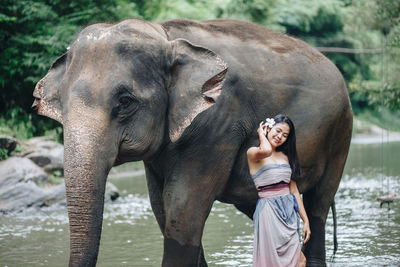 Full length of young woman standing in water