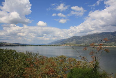 Scenic view of lake and mountains against sky