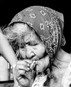 Close-up of senior woman smoking cigarette