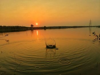 Scenic view of lake against sky during sunset