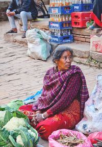 Woman sitting at market stall