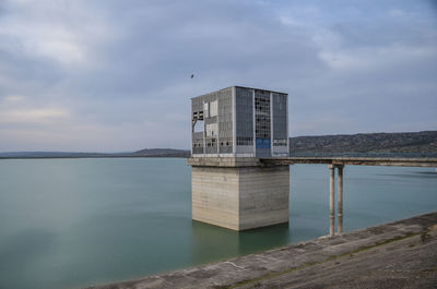 Building by sea against sky