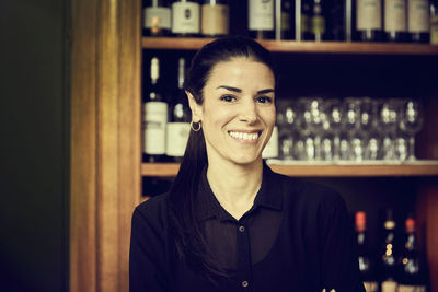 Portrait of smiling owner standing in cafe