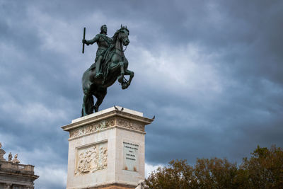 Low angle view of statue against cloudy sky