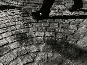 Low section of man on cobblestone