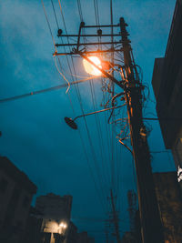 Low angle view of illuminated buildings against sky at dusk