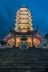 Low angle view of illuminated building against sky at dusk