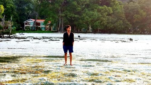 Full length rear view of man walking on beach