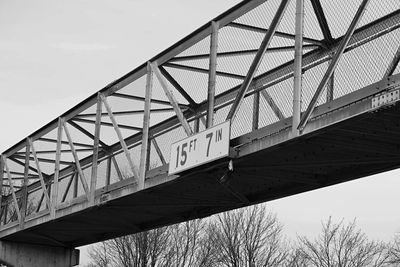 Low angle view of elevated walkway against sky