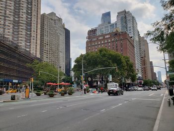 City street and buildings against sky