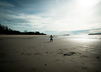 Man on beach against sky