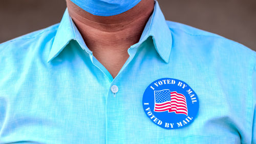 Low section of person standing against blue wall