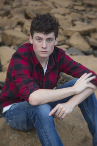 Portrait of young man sitting outdoors