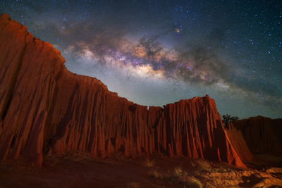 Scenic view of mountains against sky at night