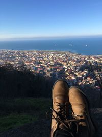 Shoes against cityscape in sunny day